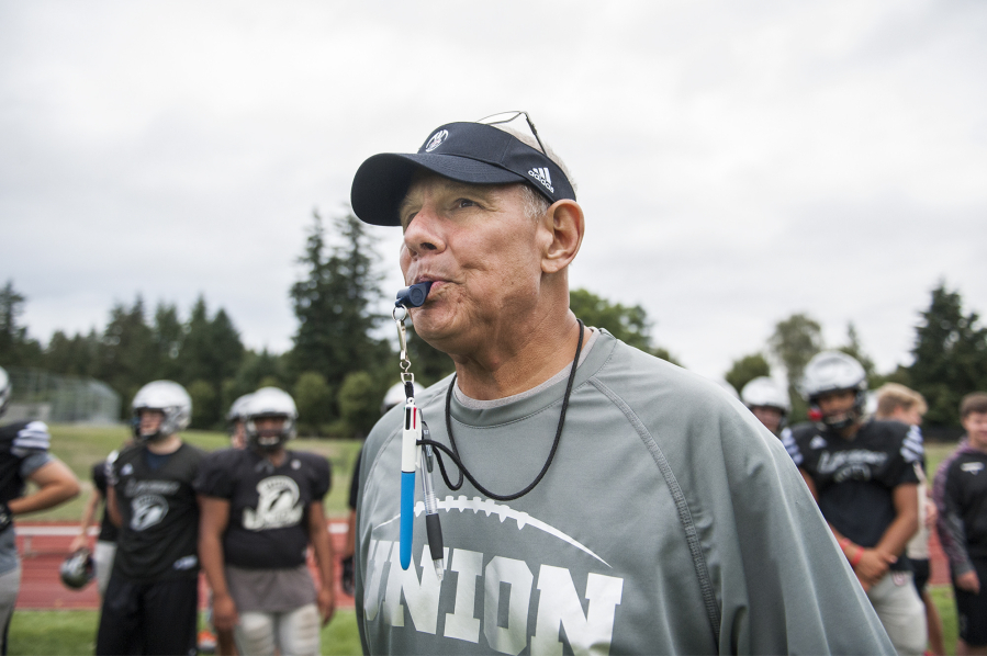 Mark Rego, Union High School assistant football coach, blows his whistle to indicate a downed ball during a two-minute drill at a Union practice on Thursday afternoon, Aug. 23, 2018.