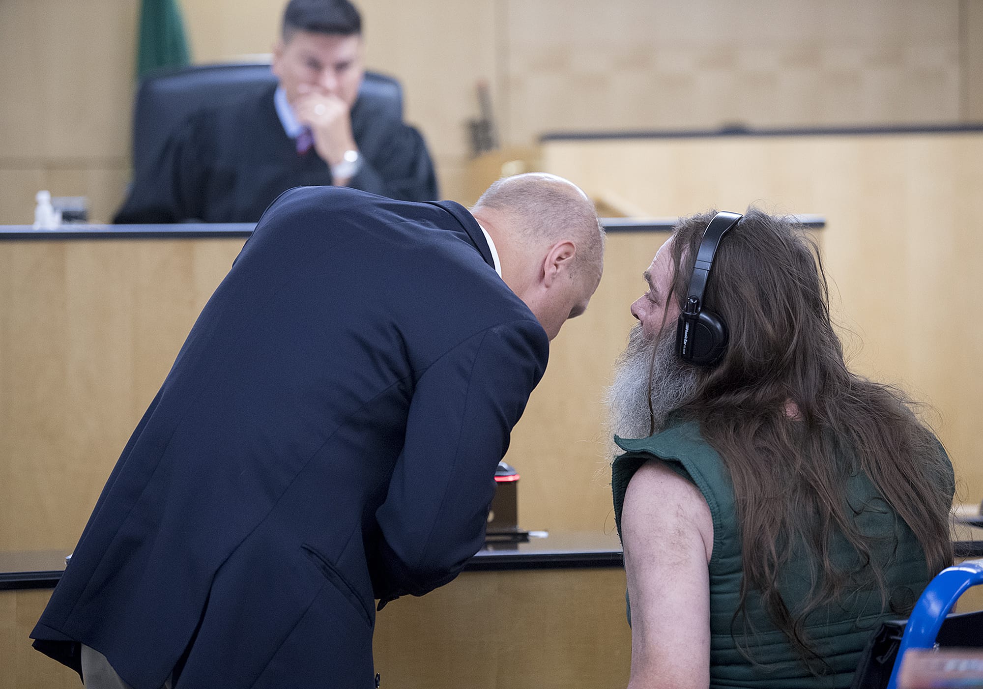 Timothy J. White, 59, right, makes a first appearance in Clark County Superior Court on Thursday morning, Aug. 23, 2018 while facing allegations he threatened staff at PeaceHeath Southwest Medical Center. White is wearing headphones to help aid his hearing.