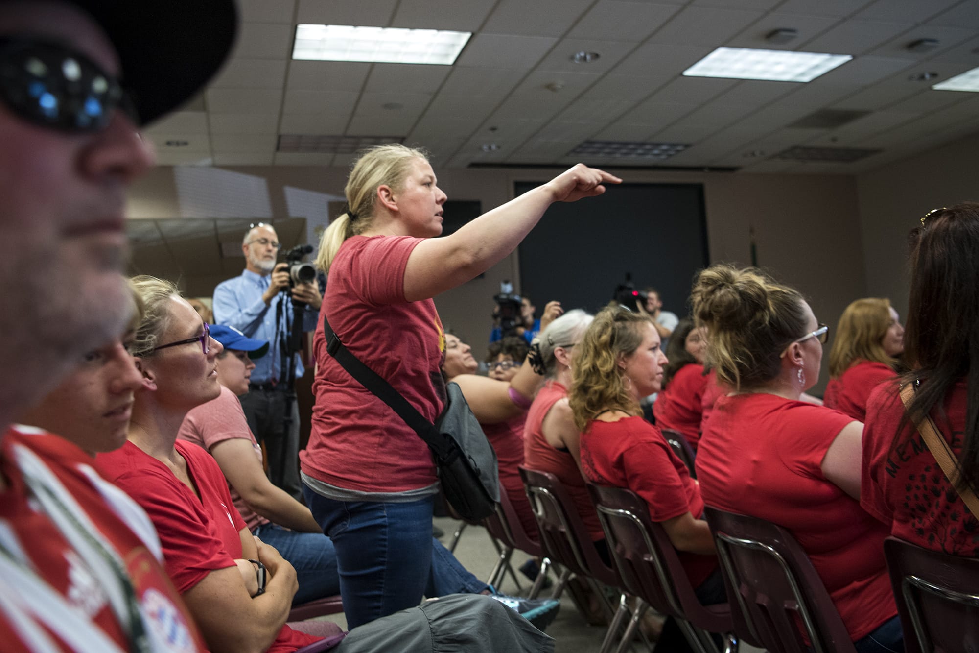 Katie Scot of Vancouver shouts out to the board as they call for a motion to move the meeting into another location during the Vancouver Public Schools board meeting on Tuesday. Scot's son attends Harney Elementary School, and Scot came to the meeting to support the teachers.