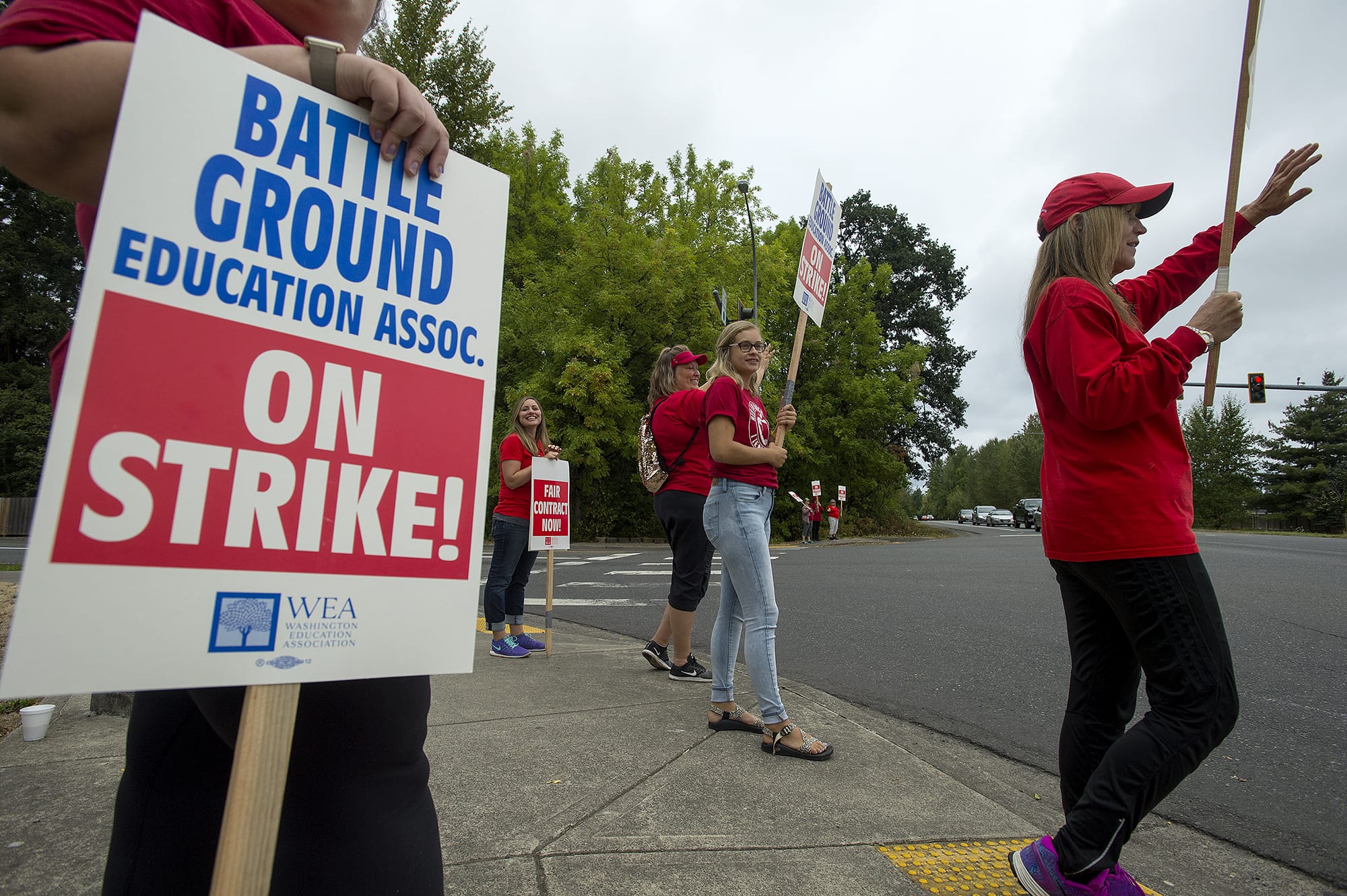 Teachers and supporters greet motorists along Northwest 10th Avenue while sign waving during the strike in Battle Ground on Thursday morning, Aug. 30, 2018.