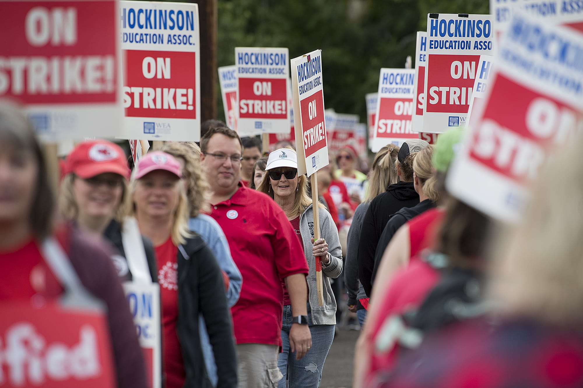 Hockinson teachers and supporters march with signs outside Hockinson Middle School on Friday morning, Aug. 31, 2018.