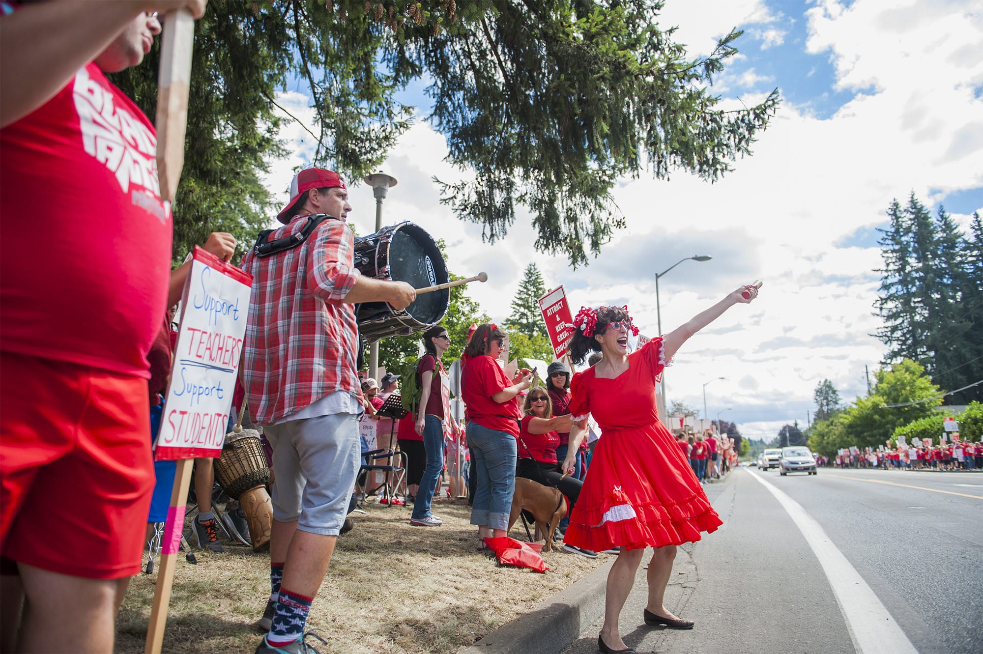 Marta Gray, 7th grader teacher at Thomas Jefferson Middle School, right, leads a cheer while teachers rally in front of the Vancouver Public Schools' Administration Building on Friday afternoon, Aug. 31, 2018.