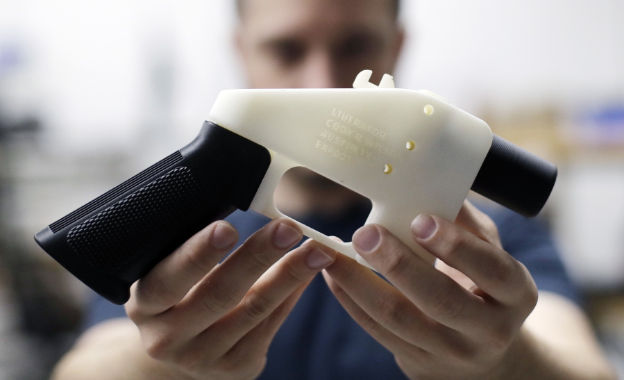 Cody Wilson, with Defense Distributed, holds a 3D-printed gun called the Liberator at his shop in Austin, Texas. A federal judge in Seattle is scheduled to hear arguments Tuesday, Aug. 21, 2018, on whether to block a settlement the U.S. State Department reached with a company that wants to post blueprints for printing 3D weapons on the internet.