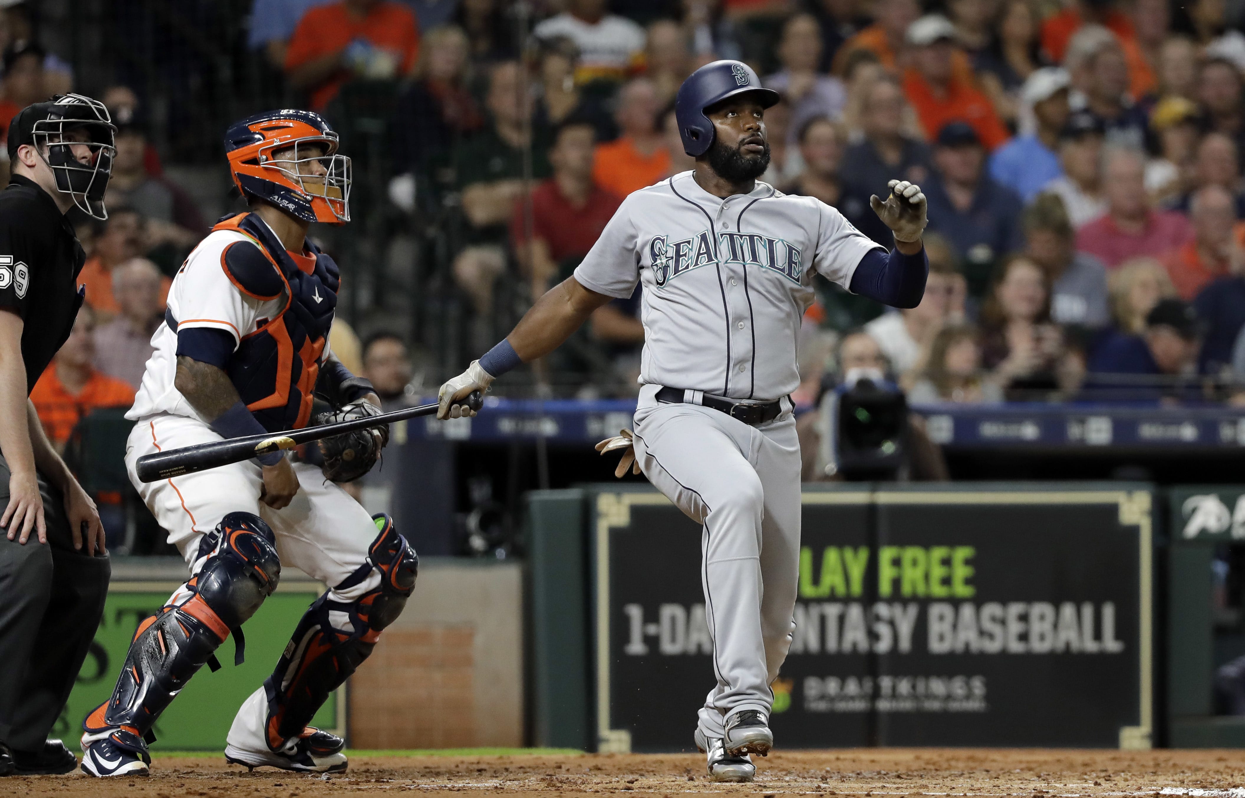 Seattle Mariners' Denard Span watches his two-run home run in front of Houston Astros catcher Martin Maldonado during the second inning of a baseball game Thursday, Aug. 9, 2018, in Houston. (AP Photo/David J.
