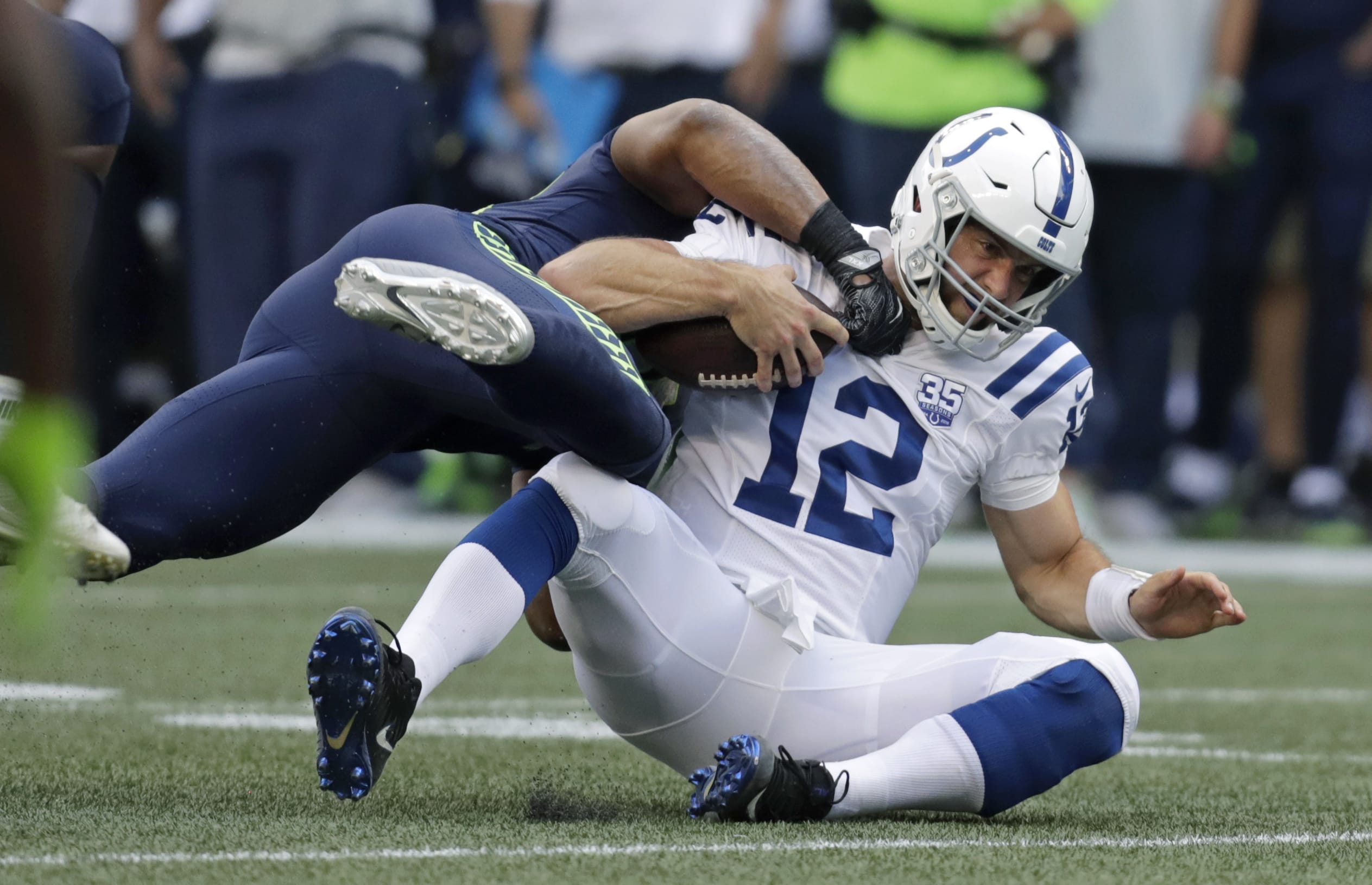 Indianapolis Colts quarterback Andrew Luck (12) is tackled by Seattle Seahawks linebacker Bobby Wagner during the first half of an NFL football preseason game, Thursday, Aug. 9, 2018, in Seattle.