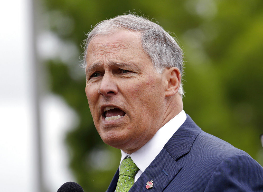 FILE - In this June 21,2018, file photo, Washington Gov. Jay Inslee speaks at a news conference in SeaTac, Wash. Inslee says the state plans to sue the Trump administration over its proposal to dismantle Obama-era pollution rules that would have increased federal regulation of emissions of coal-fired power plants. Inslee, a Democrat, told reporters Wednesday, Aug. 22, 2018, that the Environmental Protection Agency plan threatens lives and is also illegal.