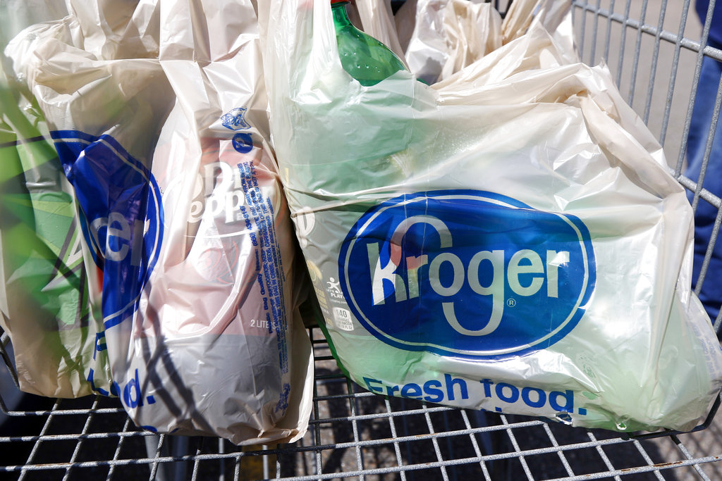 FILE - This June 15, 2017, file photo shows bagged purchases from the Kroger grocery store in Flowood, Miss. The nation’s largest grocery chain will phase out the use of plastic bags in its stores by 2025. (AP Photo/Rogelio V.