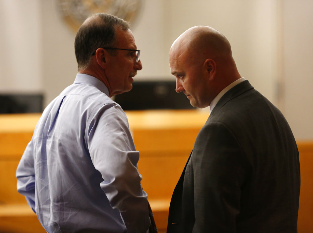 Defendant Roy Oliver, right, a fired Balch Springs police officer charged with the murder of 15-year-old Jordan Edwards, and his defense attorney Bob Gill speak after seeing a question from the jury indicating they can't reach a unanimous verdict during a trial of Oliver at the Frank Crowley Courts Building in Dallas on Tuesday, Aug. 28, 2018. Oliver was convicted of murder on Tuesday for fatally shooting an unarmed black teenager when he fired into a car full of teenagers leaving a house party in suburban Dallas.