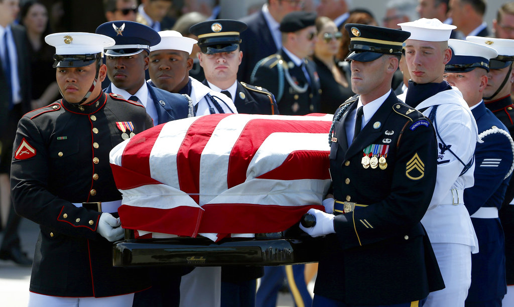 A military honor guard carries the casket of Sen. John McCain, R-Ariz., after a memorial service at North Phoenix Baptist Church Thursday, Aug. 30, 2018, in Phoenix. (AP Photo/Ross D.