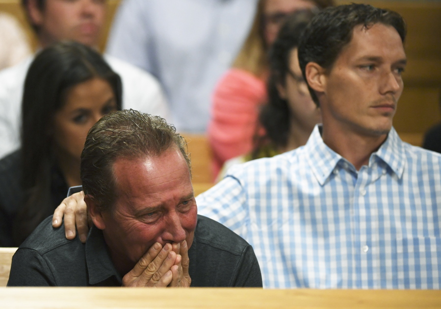 Frank Rzucek, the father of Shanann Watts, left, and her brother, Frankie Rzucek, react in court Tuesday at Christopher Watts’ arraignment hearing in Greeley, Colo.