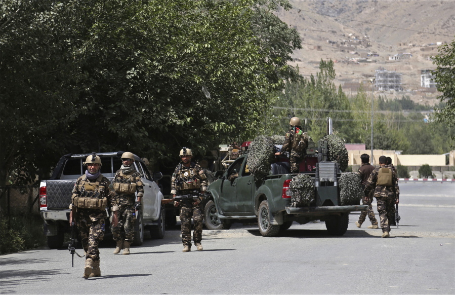 Afghan security forces arrive at the site of an attack Thursday in Kabul, Afghanistan. Gunmen besieged a compound belonging to the Afghan intelligence service.