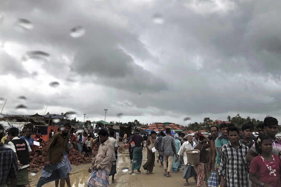 Rohingya refugees walk on a muddy road in the rain through Jamtoli refugee camp in Bangladesh. For the hundreds of thousands of Rohingya children living in Bangladesh’s refugee camps, dangers lurk everywhere: from malnutrition and disease to human traffickers to flooding and landslides.