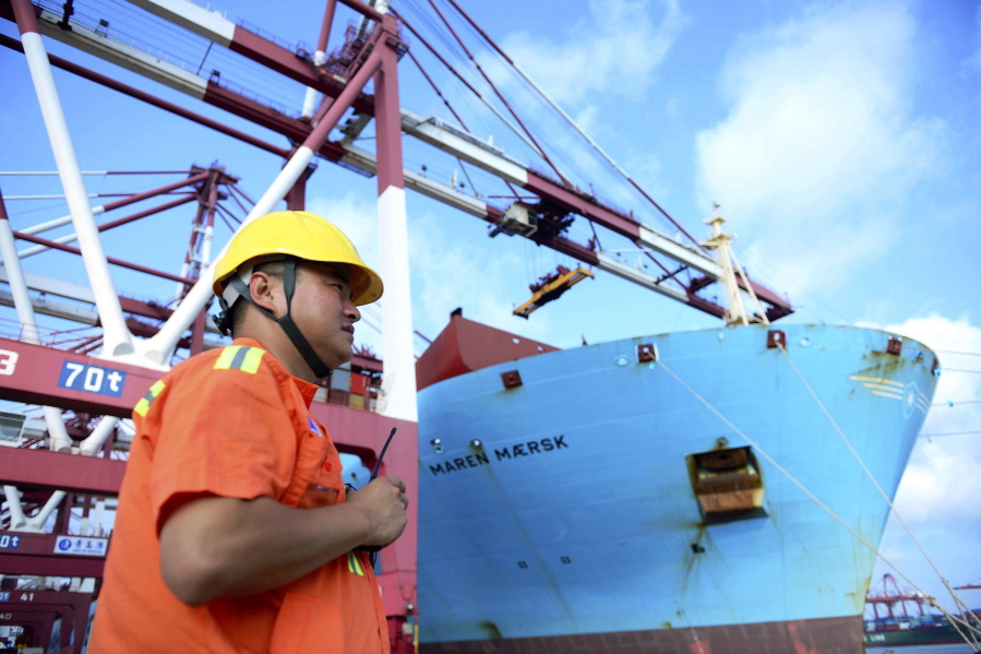 A worker stands near a container ship at a port in Qingdao in eastern China’s Shandong Province. Beijing is responding to U.S. President Donald Trump’s tariff hikes by pressing companies to find more non-U.S. suppliers and customers. But there are few substitutes for the United States as a market and technology supplier.