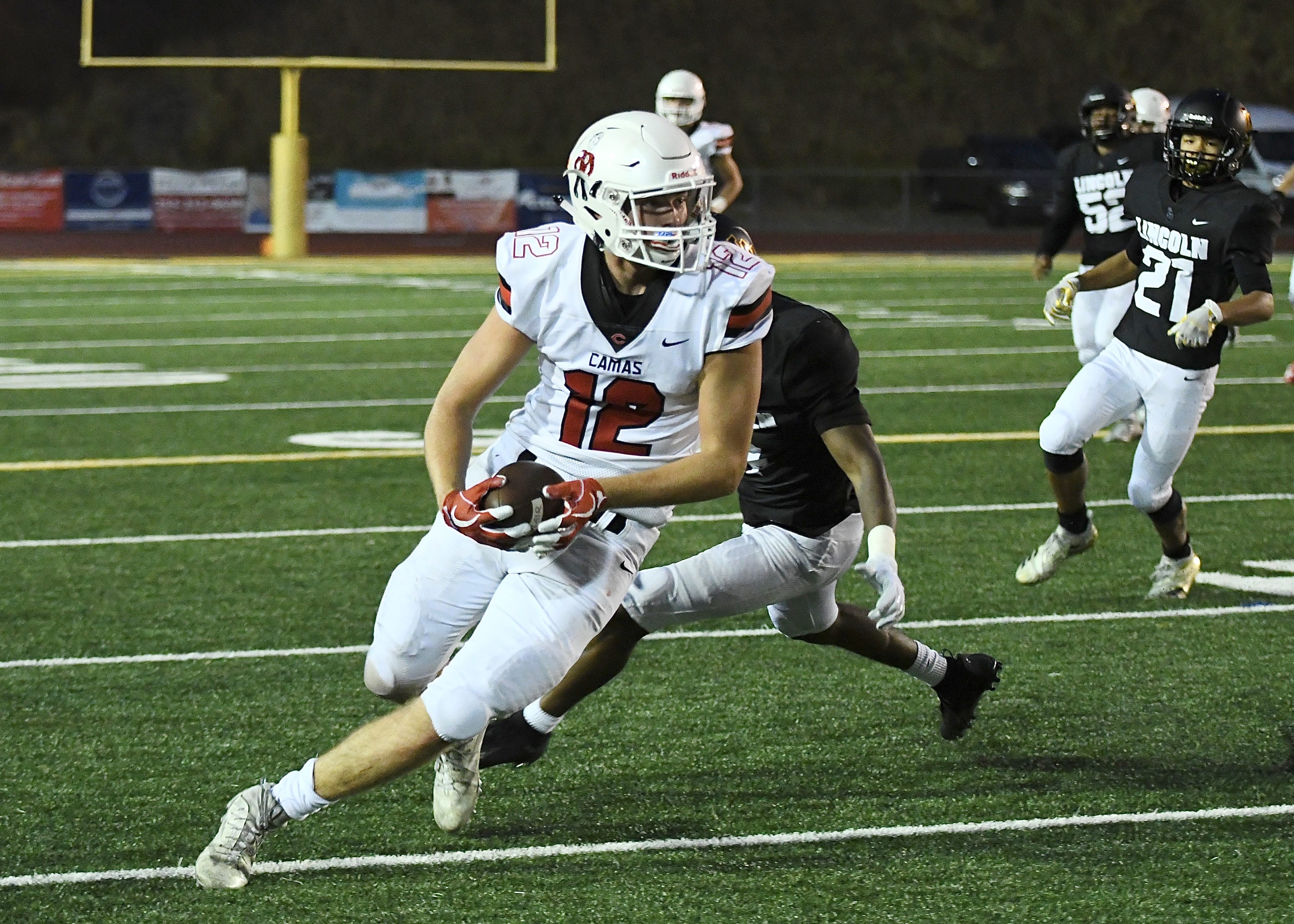 Shane Jamison (12) scores a touchdown for Camas (Kris Cavin for The Columbian)