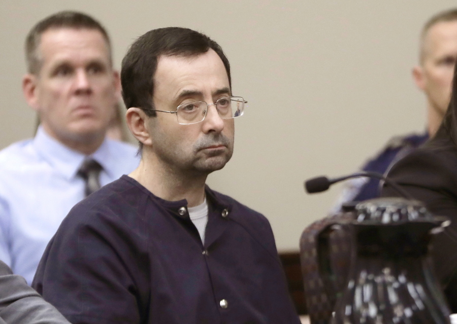 Larry Nassar, a former doctor for USA Gymnastics and member of Michigan State’s sports medicine staff, sits in court during his sentencing hearing in Lansing, Mich. Michigan State University said Thursday, Aug. 30, 2018, that the NCAA has cleared it of any rules violations in the Nassar sexual-assault scandal. Nassar pleaded guilty to assaulting girls and women while working as a campus sports doctor for Michigan State athletes and gymnasts in the region.