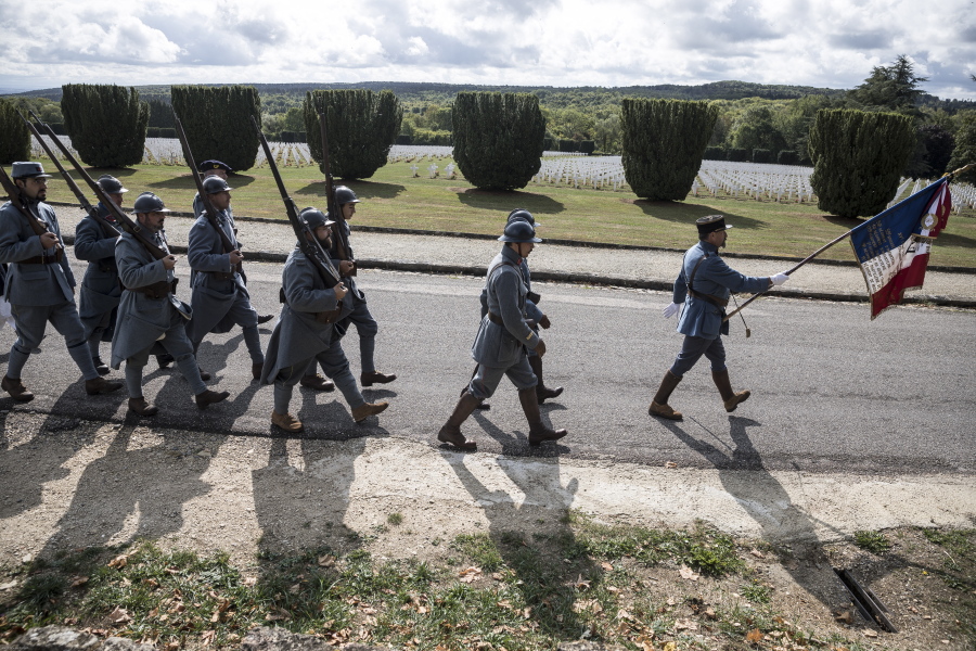Men dressed in WWI uniforms march during a reconstruction of the WWI battle of Verdun, Saturday, Aug. 25, 2018 in Verdun, eastern France. Hundreds of volunteers from 18 countries gathered in the French town Verdun as part of a string of events to mark the centenary of the end of World War One. Re-enactors dressed in soldiers’ uniforms have brought to life a big military encampment in the town.