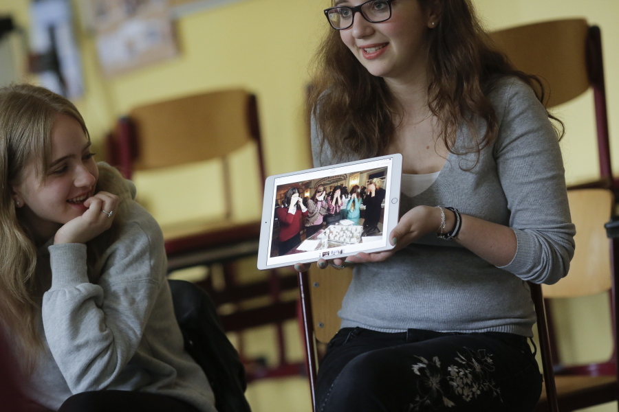 Jewish teenager Sophie Steiert, right, shows a picture of Jewish daily life on a tablet computer June 25 as Laura Schulmann looks on during a lesson as part of a project of religions at the Bohnstedt-Gymnasium high school in Luckau, Germany.