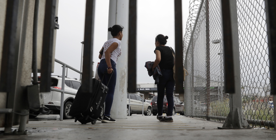 Sisters from Guatemala seeking asylum cross a bridge from Matamoros, Mexico, to a port of entry into the United States in Brownsville, Texas, on June 20.
