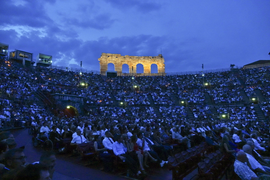 Spectators watch Rossini’s ‘‘Barbiere di Siviglia’’ at the Verona Arena, in Verona, Northern Italy, Saturday, Aug. 4, 2018. After the colossal Roman-era Verona Arena amphitheater lost audience and prestige, nearly closing two seasons ago under a mountain of debt, artists and public that have sustained it are putting hopes for a relaunch in 57-year-old former singer Cecilia Gasdia, in her first season as general manager.