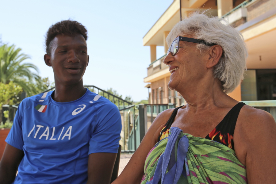 Asylum seeker from Mali, Moriba Mamadou Diarra, 18, shares a light moment with Barbara Di Clemente, 79-year-old Italian grandmother, at a sports centre near their home, in Rome. Di Clemente has been hosting Diarra in her home for a few months now, through a program called “Refugees Welcome” where Italian families can apply to open their homes and host young refugees in need.