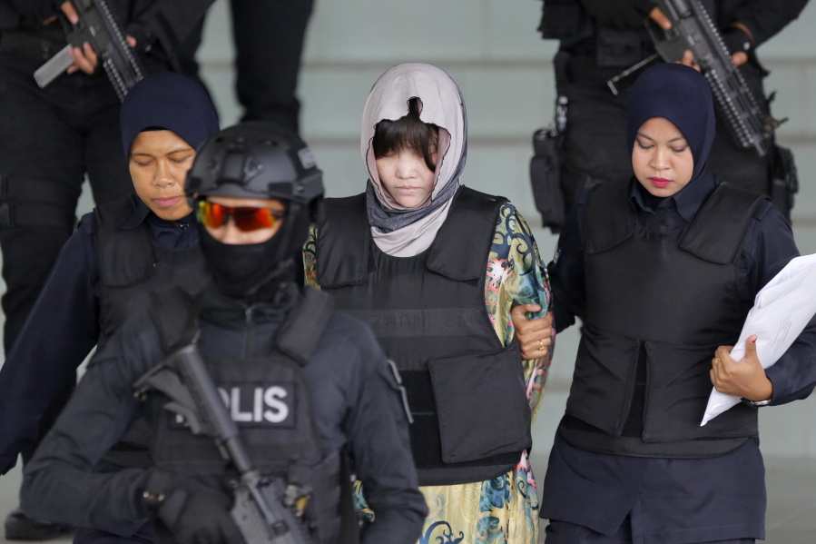 Vietnamese Doan Thi Huong, center, is escorted by police as she leaves her court hearing at the Shah Alam High Court in Shah Alam, Malaysia, on Thursday. The Malaysian court has ordered the two women, Doan Thi Huong and Indonesian Siti Aisyah to enter their defense over the murder of North Korean leader’s half-brother in a brazen assassination that has gripped the world.