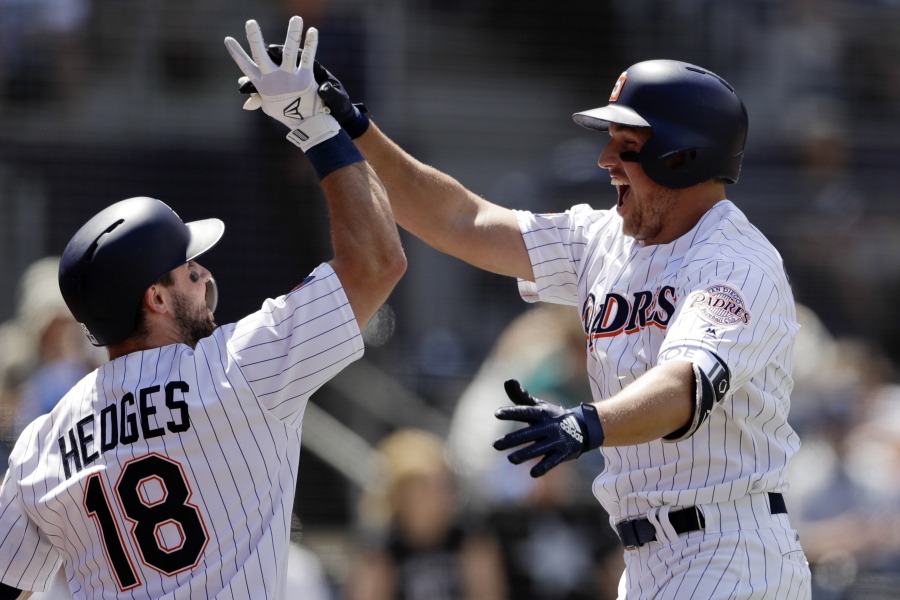 San Diego Padres’ Hunter Renfroe, right, celebrates with teammate Austin Hedges (18) after hitting a three-run home run in the third inning of a baseball game against the Seattle Mariners, Wednesday, Aug. 29, 2018, in San Diego.