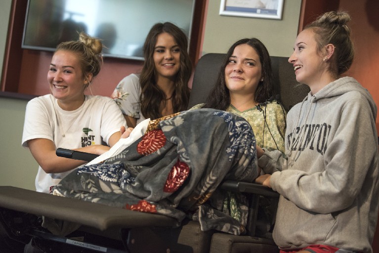 From left: Masey Tucker, Kaytlin Holgerson, Jordan Holgerson and Taylor Lavigne joke with the media about Jordan Holgerson's injuries while speaking at PeaceHealth Southwest Medical on Thursday. Holgerson was injured when she was pushed off a bridge at Moulton Falls Regional Park on Tuesday.