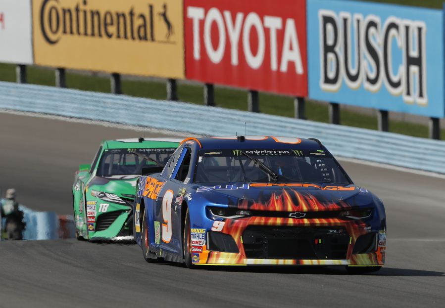 Chase Elliott (9) leads Kyle Busch (18) during a NASCAR Cup series auto race, Sunday, Aug. 5, 2018, in Watkins Glen, N.Y.
