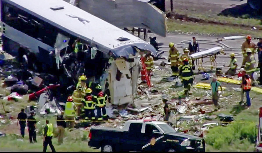 This photo from video provided by KQRENews13 shows first responders working the scene of a collision between a Greyhound passenger bus and a semi-truck on Interstate 40 near the town of Thoreau, N.M., near the Arizona border, on Thursday. Multiple people were killed and others were seriously injured. Officers and rescue workers were on scene but did not provide details about how many people were killed or injured, or what caused the crash.