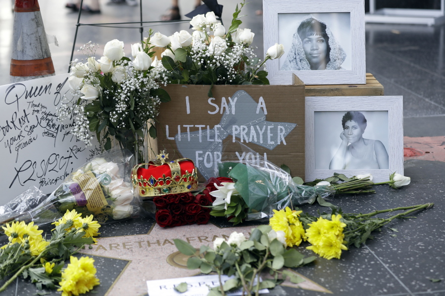 Flowers and signs are placed on Aretha Franklin’s star at the Hollywood Walk of Fame Thursday in Los Angeles. Franklin died Thursday at 76.