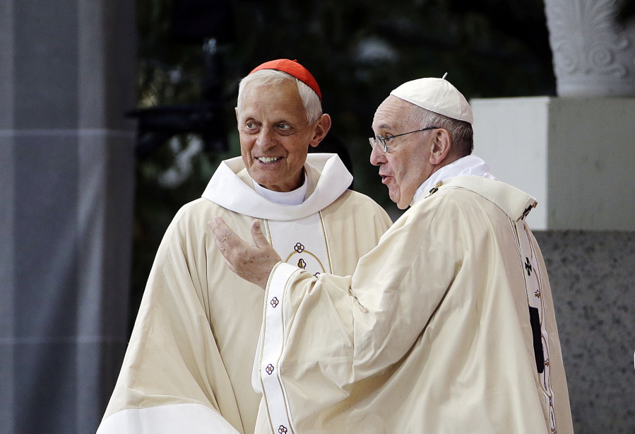 Cardinal Donald Wuerl, archbishop of Washington, left, looks toward the crowd with Pope Francis following a Mass outside the Basilica of the National Shrine of the Immaculate Conception in Washington. Wuerl wrote to priests to defend himself on the eve of the scheduled Tuesday, Aug. 14, 2018, release of a grand jury report investigating child sexual abuse in six of Pennsylvania’s Roman Catholic dioceses.