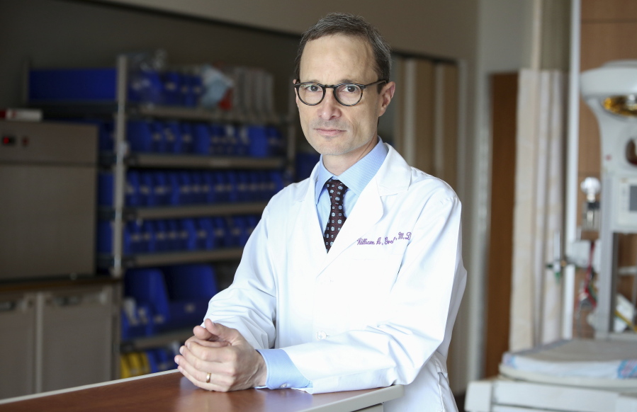 In this Aug. 7, 2018 photo, Dr. William Grobman stands for a portrait at Prentice Women’s Hospital/Northwestern Medicine in Chicago. Having an induced pregnancy doesn’t mean moms can’t have “natural childbirth” _ they can forgo pain medicine or use a hospital’s homelike birthing center rather than delivering in “an operating room in a sterile suite with a big light over your head,” says Grobman.