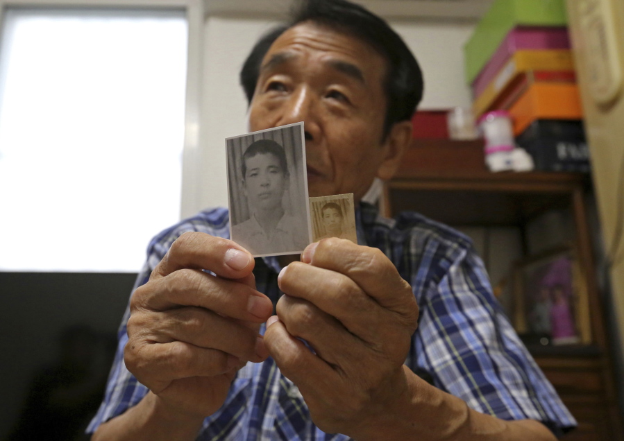 Lee Soo-nam, 76, shows photos of his brother Ri Jong Song in North Korea at his home in Seoul, South Korea, on Thursday. Lee is among about 200 war-separated South Koreans who are crossing into North Korea for meetings with relatives they haven’t seen for decades.