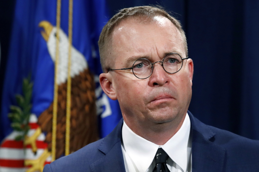 FILE- In this July 11, 2018, file photo Mick Mulvaney, acting director of the Consumer Financial Protection Bureau (CFPB), and Director of the Office of Management, listens during a news conference at the Department of Justice in Washington. Seth Frotman, the nation's top government official overseeing the $1.5 trillion student loan market resigned on Monday, citing what he says is the White House's open hostility toward protecting student loan borrowers. Frotman is the latest high-level departure from the CFPB since Mulvaney took over in late November.