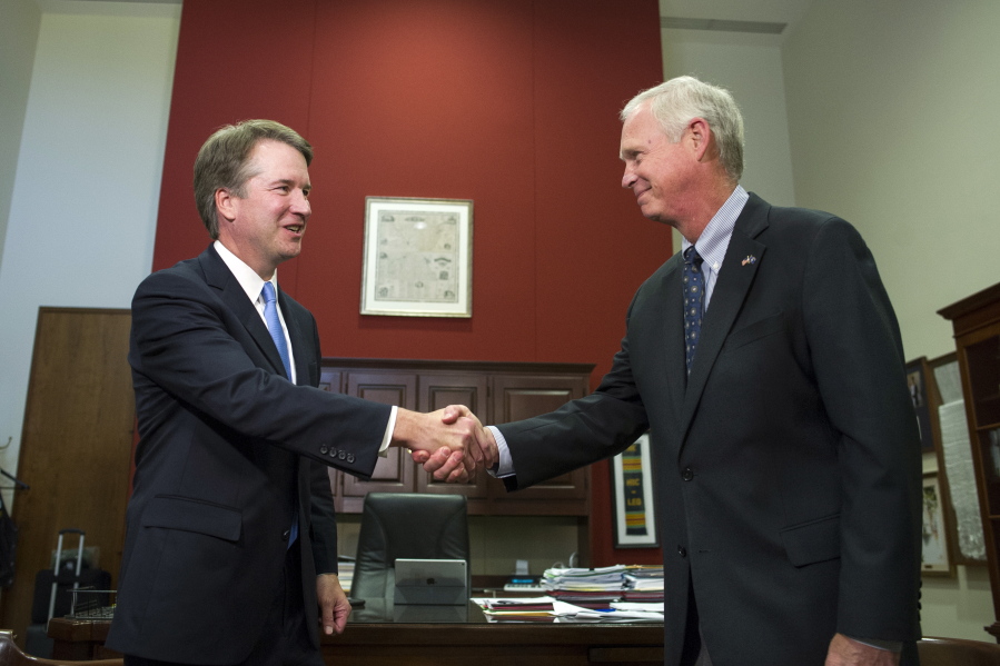 Supreme Court nominee Brett Kavanaugh shakes hands as he meets with Sen. Ron Johnson, R-Wis., right, on Capitol Hill in Washington, Wednesday, Aug. 15, 2018.