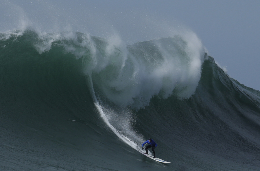 Travis Payne rides a giant wave Feb. 12, 2016, during the finals of the Mavericks surfing contest in Half Moon Bay, Calif. California Gov. Jerry Brown announced Monday that he signed a bill making surfing the official state sport.