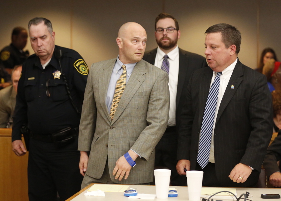 Former Balch Springs Police Officer Roy Oliver, center, looks to his defense attorney Miles Brissette, right, before being taken away after being sentenced to 15 years in prison for the murder of 15-year-old Jordan Edwards on Wednesday at the Frank Crowley Courts Building, in Dallas.