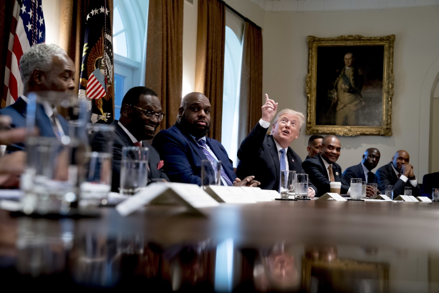 President Donald Trump points up to heaven as he speaks during a meeting with inner city pastors in the Cabinet Room of the White House in Washington on Wednesday.