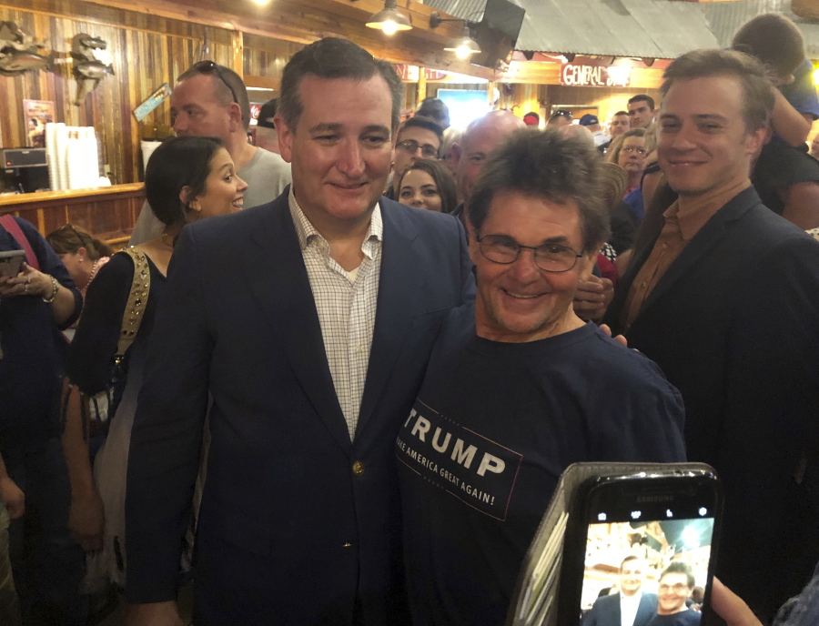 Republican U.S. Sen. Ted Cruz, left, poses with Gary Malcik following a campaign stop in Temple, Texas. Cruz says he wouldn’t be surprised if President Donald Trump comes to Texas to campaign for top Republicans like himself, who are running for re-election in November, potentially creating the latest twist in an on-again, off-again Trump-Cruz relationship that has made the two a political odd couple.