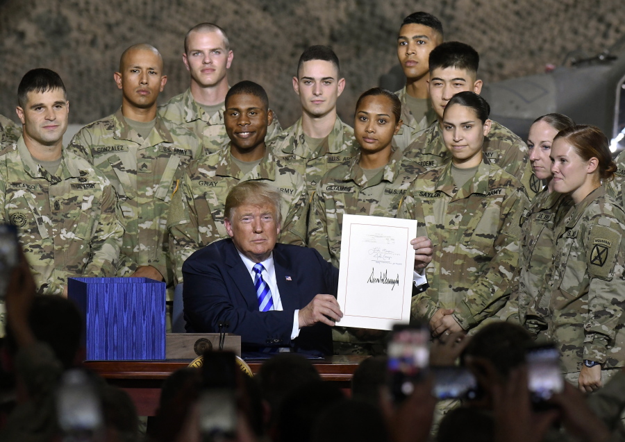 President Donald Trump signs the John McCain National Defense Authorization Act for the Fiscal Year 2019, during a signing ceremony Monday, Aug. 13, 2018, in Fort Drum, N.Y.