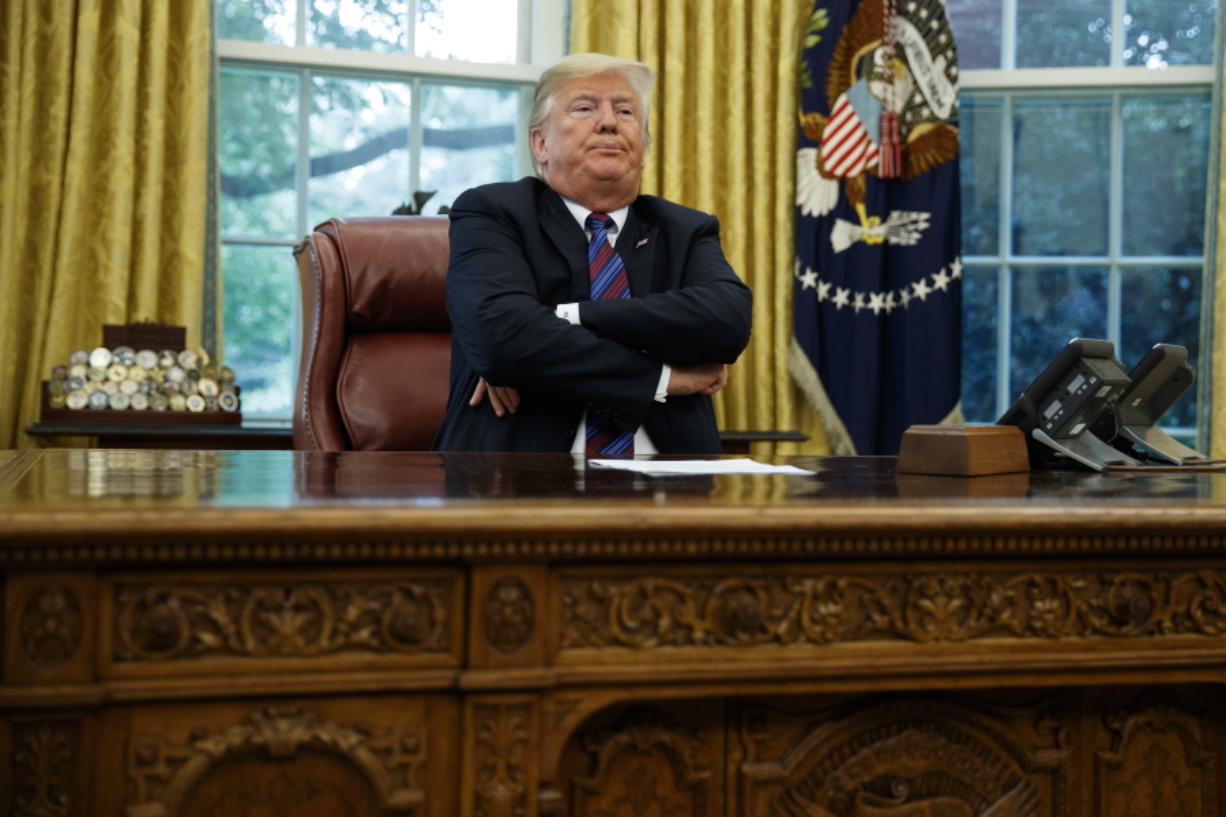 President Donald Trump crosses his arms in the Oval Office of the White House on Monday in Washington.
