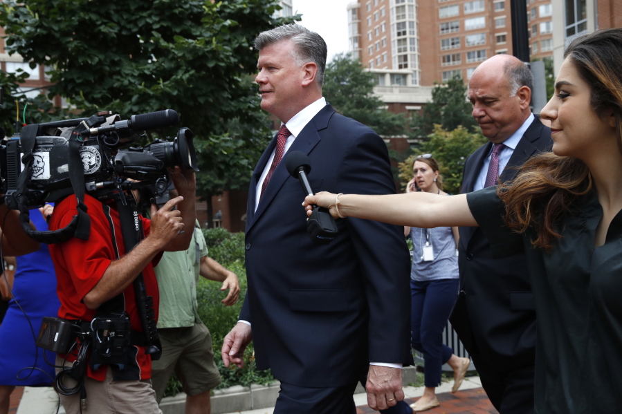 Kevin Downing, center, followed by Thomas Zehnle, both with the defense team for Paul Manafort, walk to federal court trailed by members of the media as they arrive for continuing jury deliberation in the trial of the former Donald Trump campaign chairman, in Alexandria, Va., on Monday.