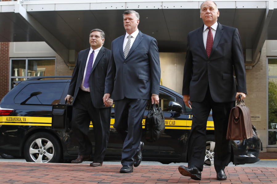 Defense attorneys Richard Westling, left, Kevin Downing, and Thomas Zehnle, walk to federal court as jury deliberations begin in the trial of former Trump campaign chairman Paul Manafort, in Alexandria, Va., on Thursday.