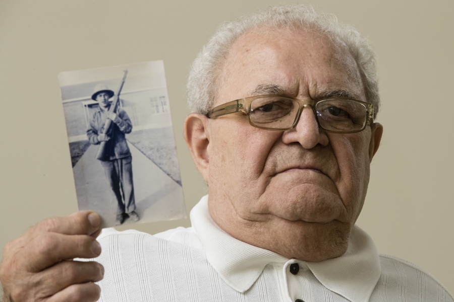 Dominic Ragucci poses for a portrait in Philadelphia with a photo of his brother, Emil, who was killed in action during World War II. Nearly 70 years after Emil’s death in the South Pacific Battle of Tarawa, his remains are scheduled to return home to Philadelphia on Monday, Aug. 13, 2018.