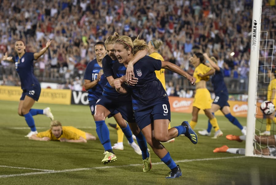 Lindsey Horan (9), hugged by teammate McCall Zerboni after scoring a goal against Australia, is currently in the final stretch of her season with the Portland Thorns.