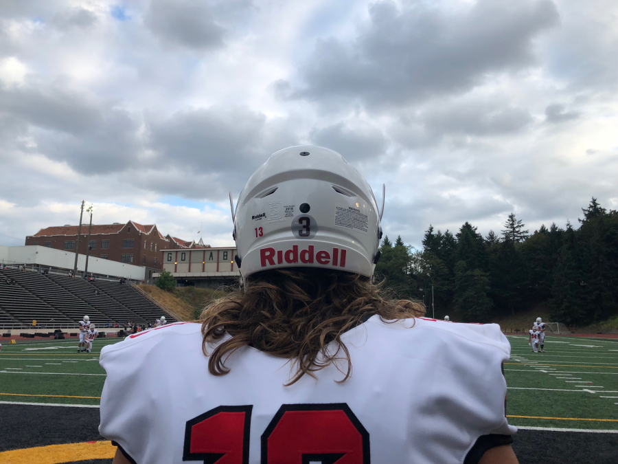 Camas receiver Luc Sturbelle warms up for the season opener at Lincoln in Tacoma, displaying the team’s new helmets. The No. 3 decal on the back of each helmet is to honor WSU quarterback Tyler Hilinski, who died by suicide in January, and raise awareness for mental health ().
