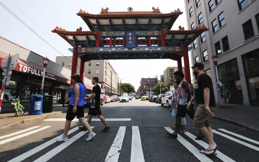 The tour group heads past the Chinese Gate on King Street dedicated a decade ago. King Street is considered the business heart of Chinatown International District, according to Don Wong, and the gate a welcoming symbol.