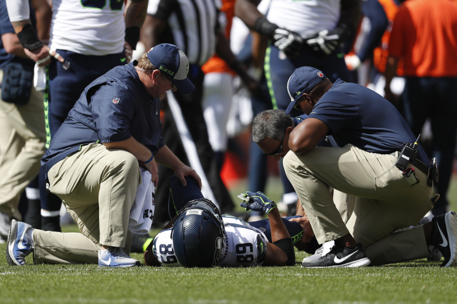 Seattle Seahawks wide receiver Doug Baldwin stays on the field injured during the first half of an NFL football game against the Denver Broncos Sunday, Sept. 9, 2018, in Denver.