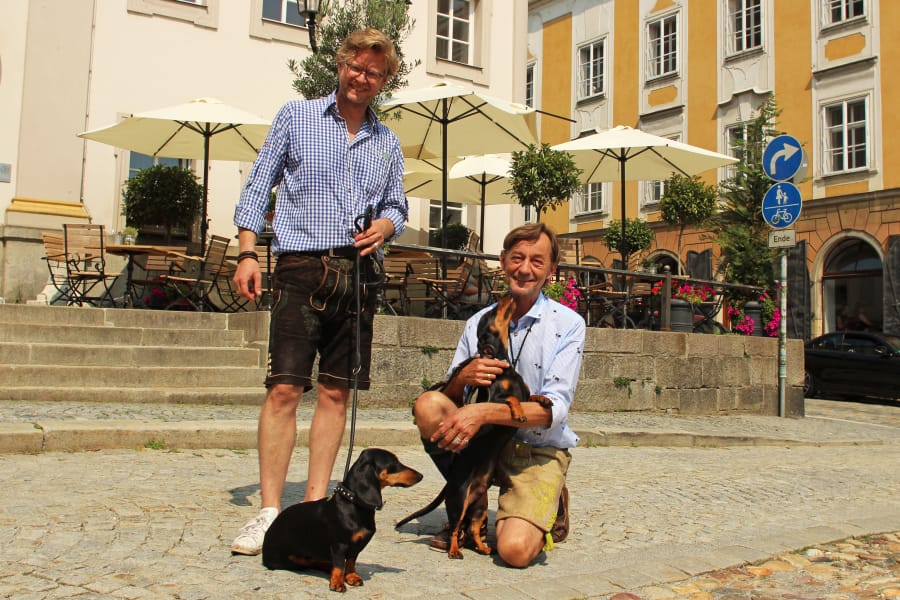 Dackelmuseum owners Oliver Storz, left, and Seppi Kublbeck, with their dachshunds Moni, left, and Little Seppi.