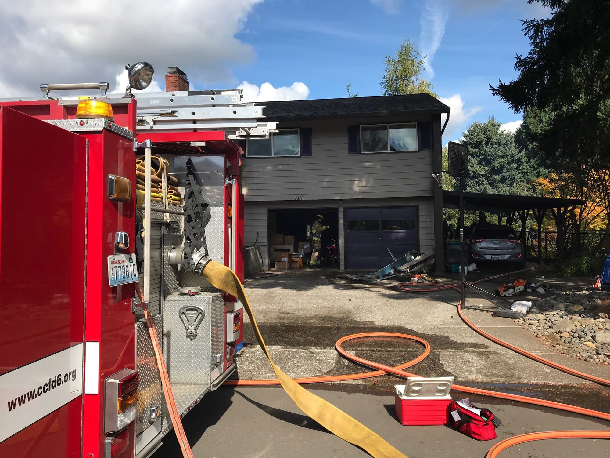 Vancouver Fire Department and Clark County Fire District 6 firefighters root through a garage in the Barberton area north of Vancouver on Sept. 20. No one was injured, and the fire was largely contained to the garage.
